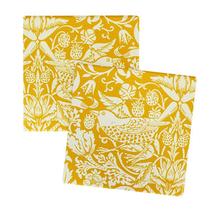 Two yellow square coasters with white floral and bird pattern on a white background