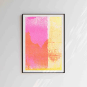 Yellow and pink risograph artwork in black frame on a white wall