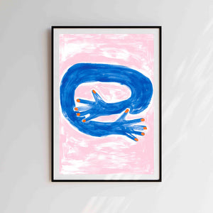 A risograph print against a white background. The print has an illustrated feel. The background is pink and there's an illustration of a arm hugging. Print is placed in a black frame against a grey wall.