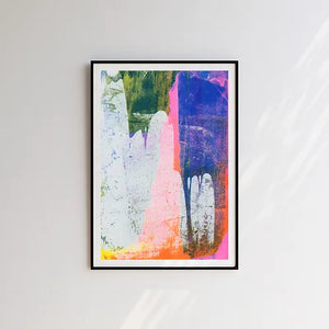 Multicoloured abstract risograph print in black frame on a wall.