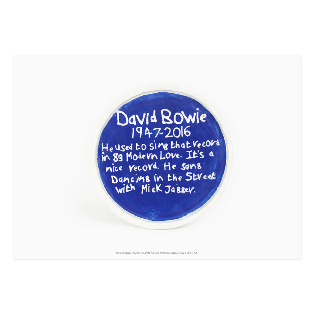 A print of a blue plaque sculpture by Horace Lindezey featuring some information about David Bowie