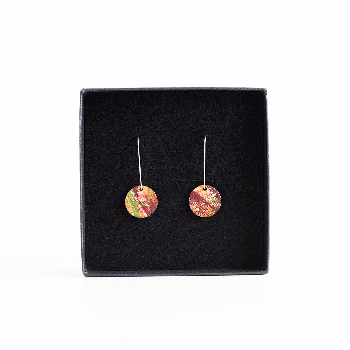 Pair of colourful earrings on a black display box
