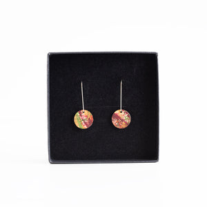 Pair of colourful earrings on a black display box