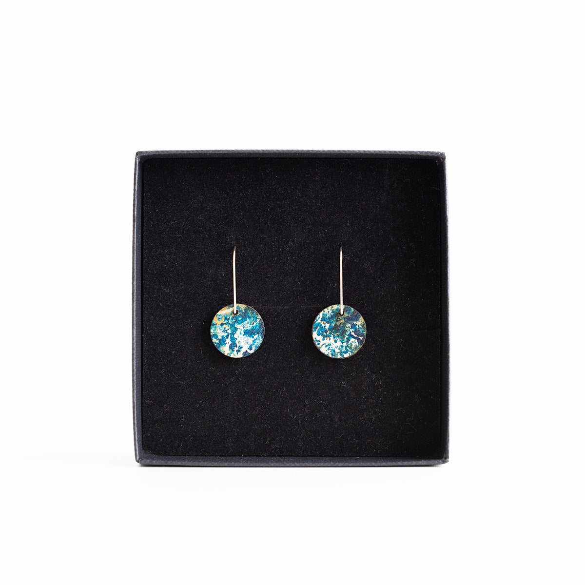 Pair of colourful earrings on a black display box