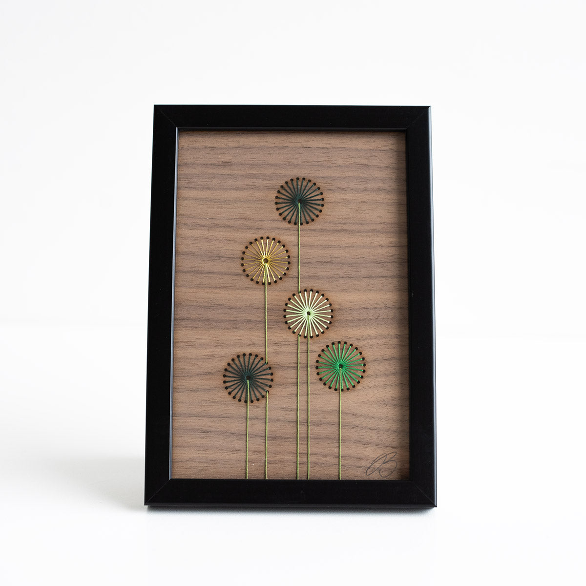 Wooden wall art with floral designs on a white background