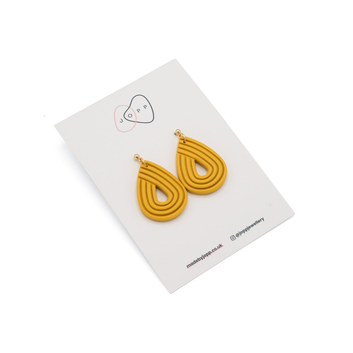 Polymer clay earrings, yellow in an upside down tear drop shape, Photographed against Jopp branded backing card.