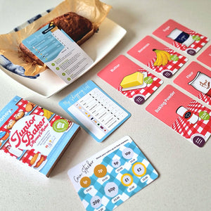 Lifestyle image of junior baker flashcards by Happy Little doers on a table.