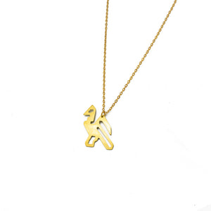 Gold pendant in the shape of a bird on a gold chain. White background.