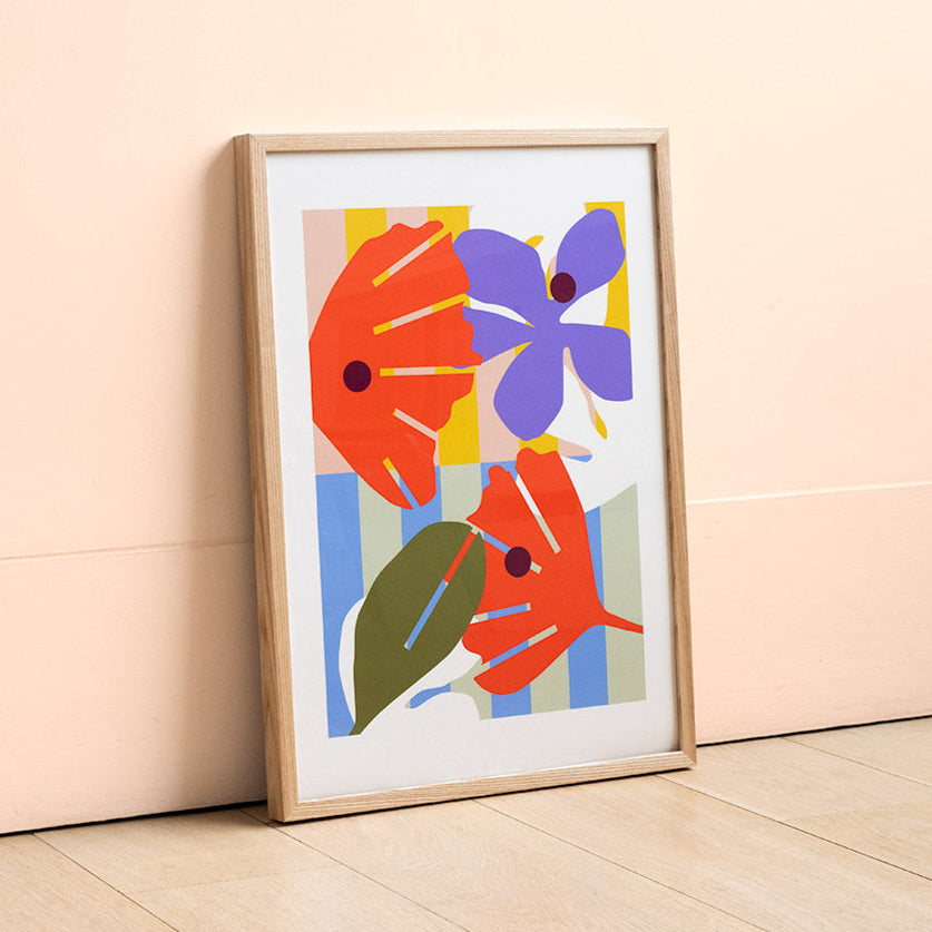 Print of digital illustration by Kate Moorhouse of colourful flowers - placed in an ash frame leant against a peach wall
