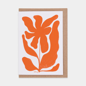 Greetings card featuring abstract orange flower. White background and brown envelope.