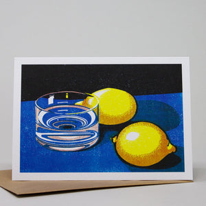 Greetings card featuring an illustration of two lemons beside a glass of water