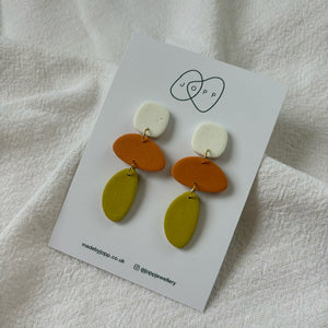 Earrings made from polymer clay, with 3 parts in different colours fastened together