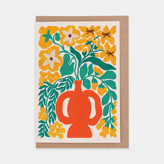 A greetings card featuring a bold and colourful illustration of flowers in a vase. Brown envelope placed inside.