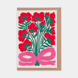 A greetings card featuring a bold and colourful illustration of roses. Brown envelope placed inside.