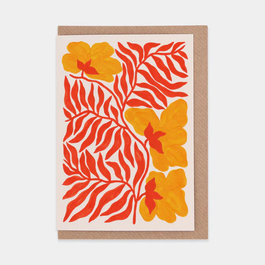 A greetings card featuring a bold and colourful illustration of yellow flowers with red leaves. Brown envelope placed inside.