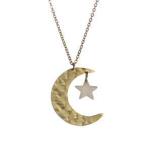 A brass gold necklace featuring a crescent moon pendant with a smaller star pendant attached to it. 