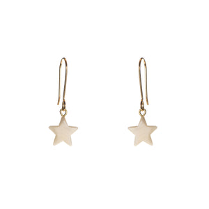 A pair of white star-shaped earrings suspended from gold hooks.