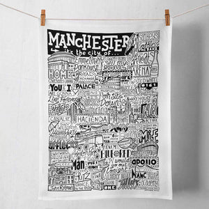 Tea towel featuring black and white illustrations of Manchester Landmarks.
