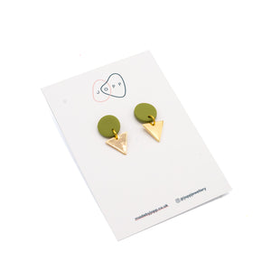 Earrings photographed against white backing card with Jopp branding. The top of each earring is a green circle with a gold triangle attached underneath.