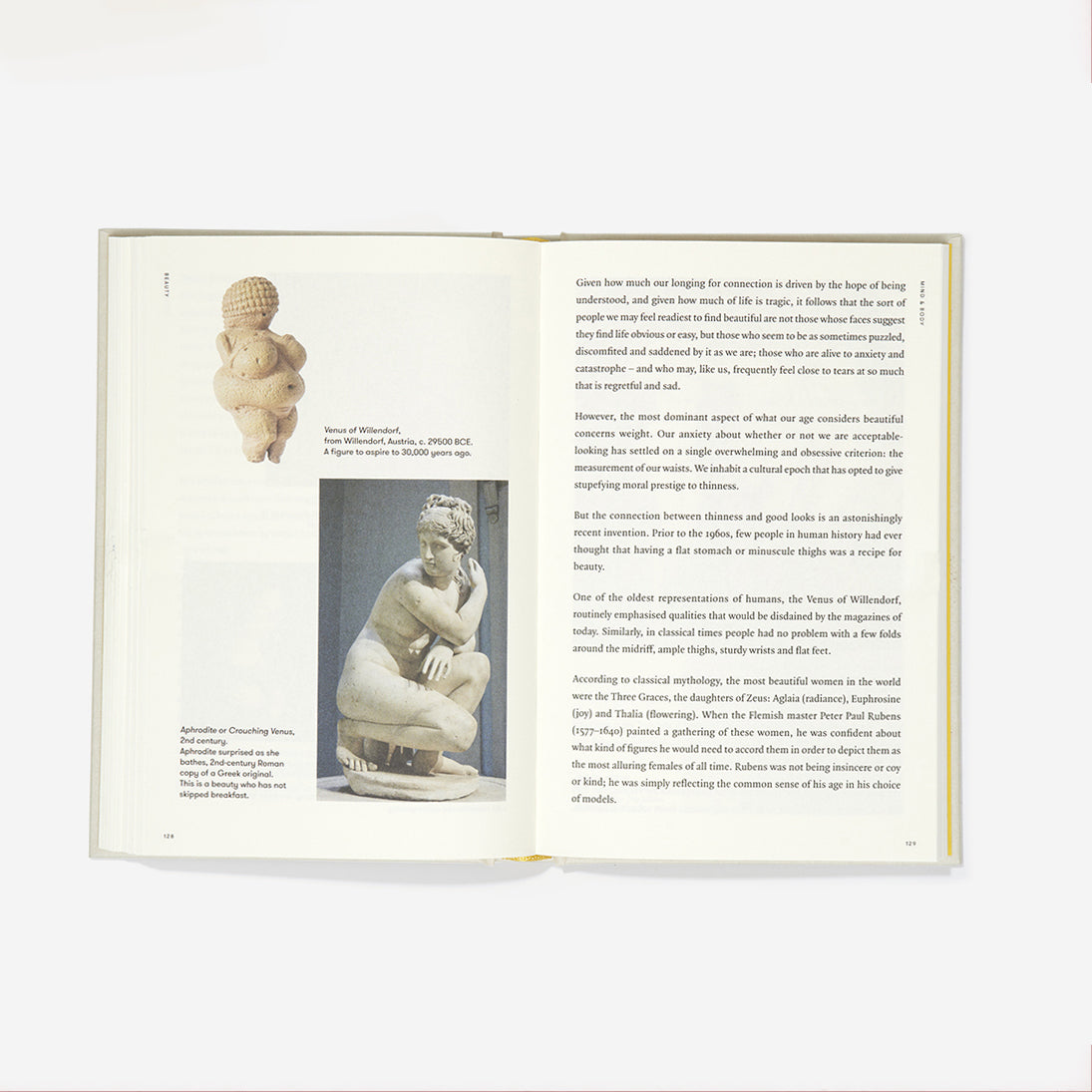Inside pages of book featuring a number of paragraphs and a photograph of a nude sculpture