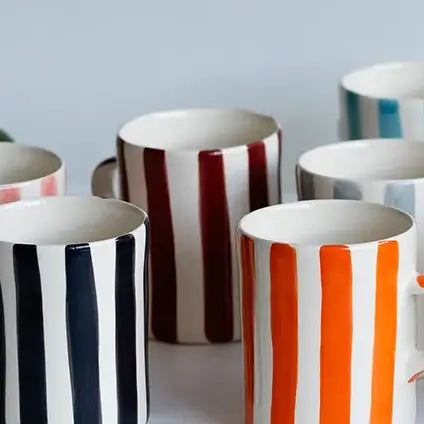 Close up of striped mugs in multiple colours