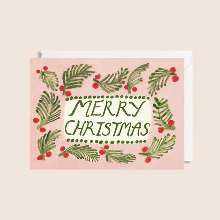 Pink Christmas card with MERRY CHRISTMAS at the centre and holly surrounding the text