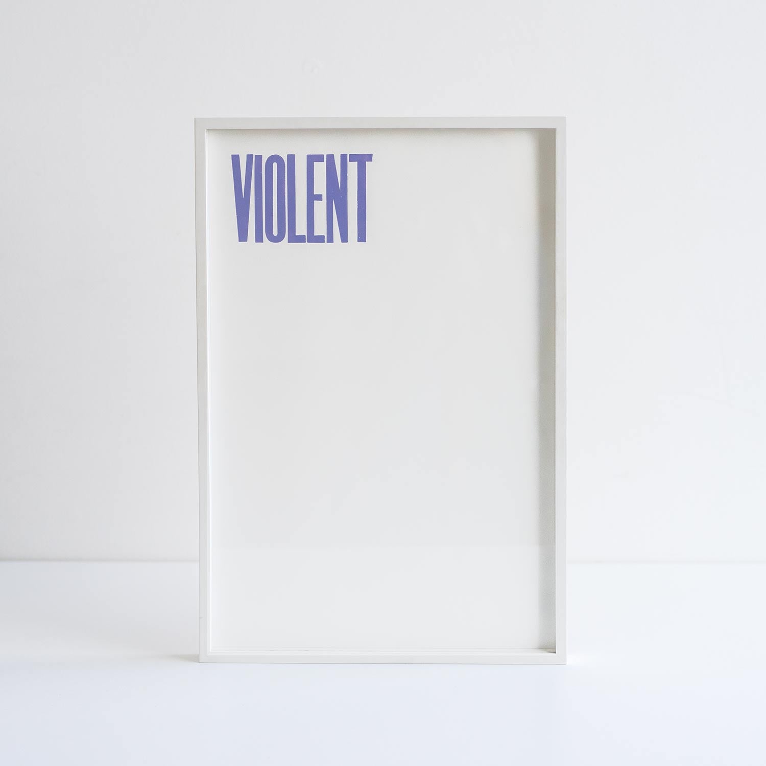 Pavel Buchler 'voilent' print in a white frame against white background