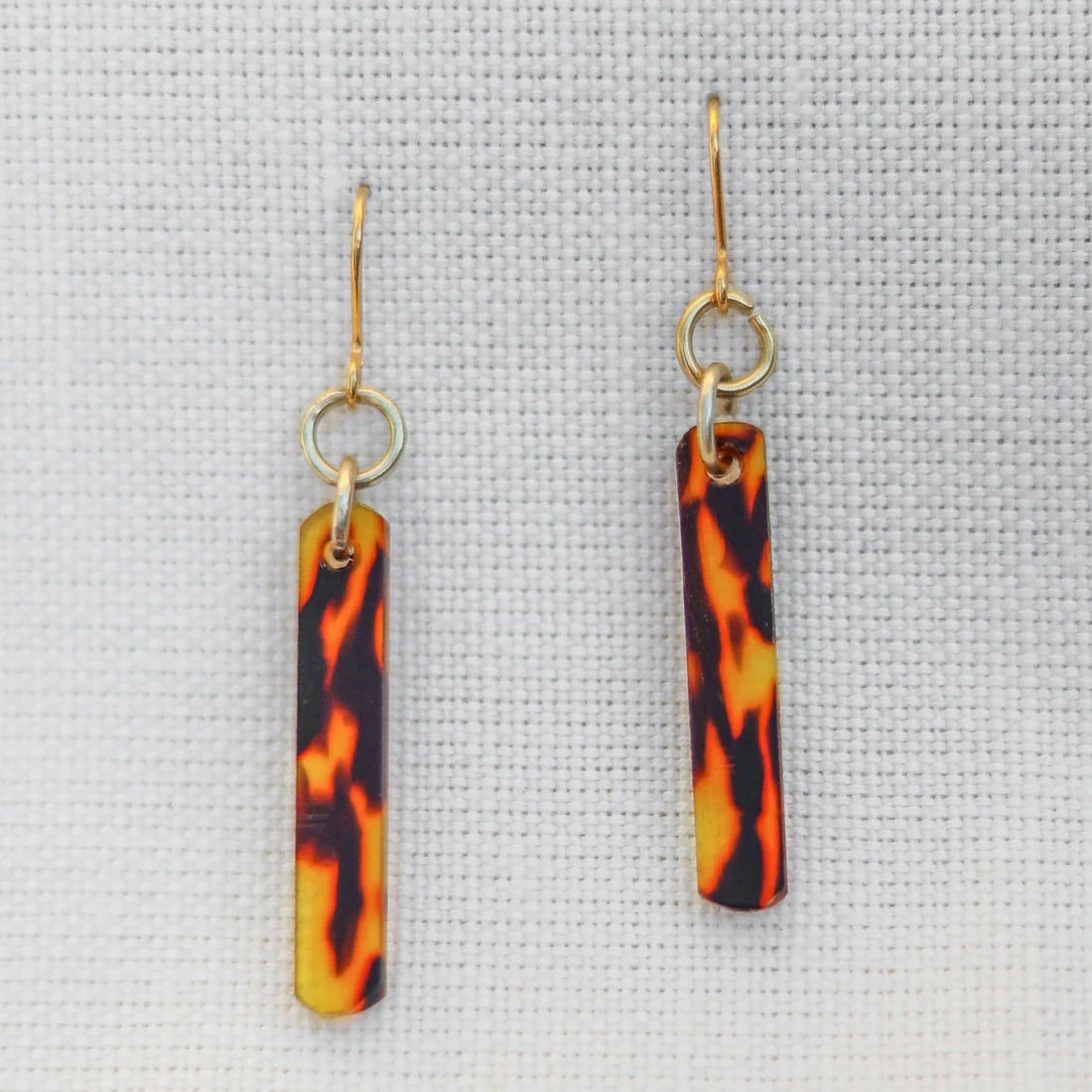 Long thin earrings made with acetate, gold hook fastenings