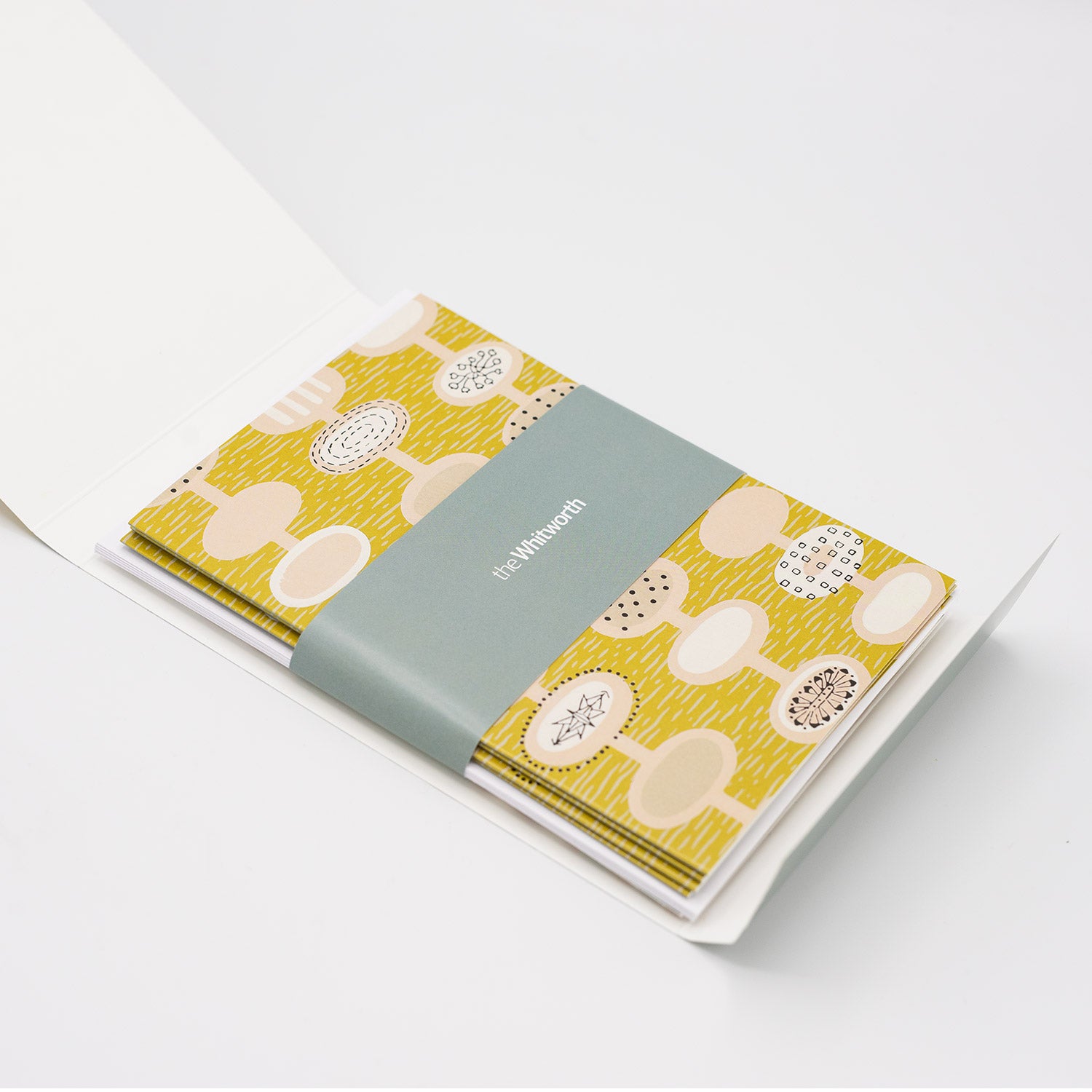 Set of greetings cards opened up to reveal the greetings card inside. The top card shows a yellow pattern design by Lucienne day.