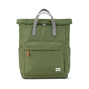 A green backpack with gray straps and a roll-top closure. The backpack has a small front pocket and a ROKA logo on the front.