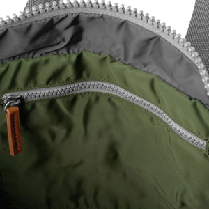 Inside of backpack focusing on grey strap.