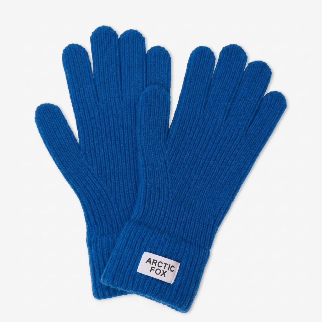 A pair of royal blue ribbed knit gloves with a white rectangular brand patch on the cuff, displayed on a light gray background.