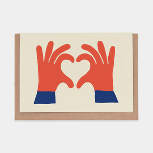 Greetings card featuring illustration of a pair of hands in the shape of a love heart. Cream background, brown envelope