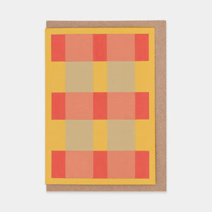 Greetings card featuring an abstract orange, red and grey check design. Brown envelope.