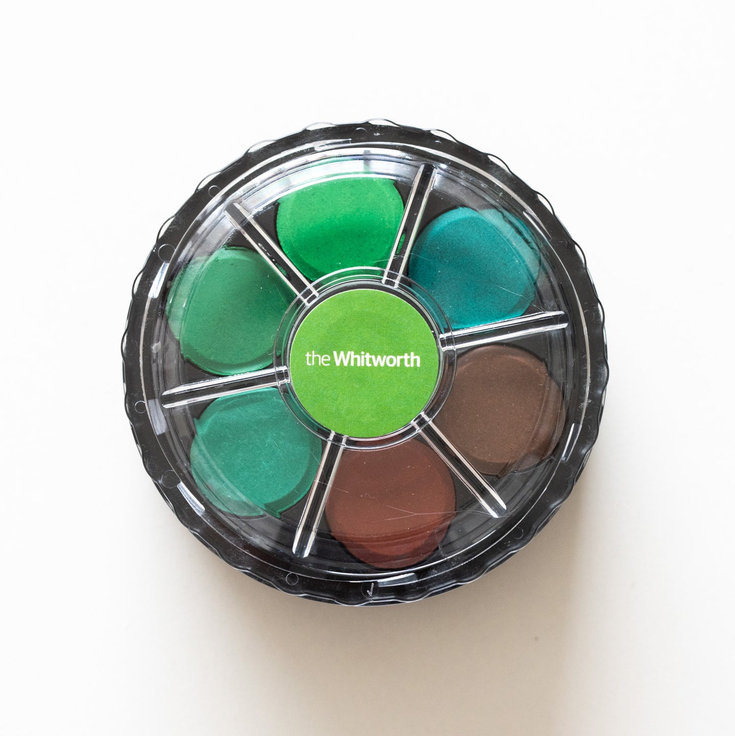 Watercolour disk set photographed from above with a green Whitworth label.