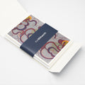 Inside of a greetings card pack with a navy Whitworth belly band.
