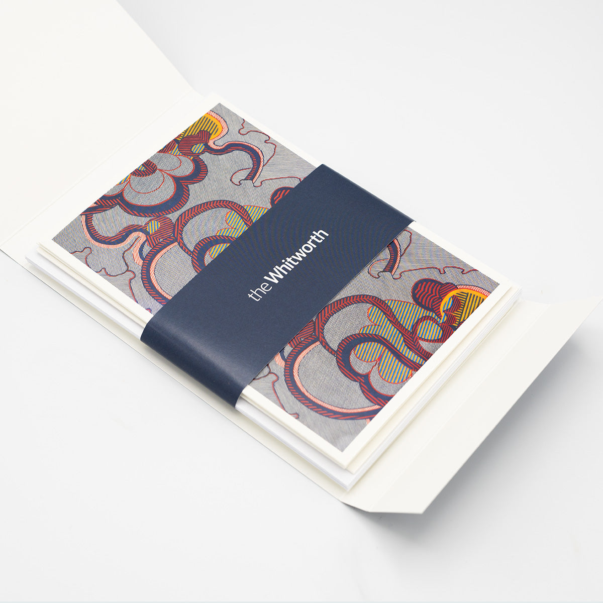 Inside of a greetings card pack with a navy Whitworth belly band.