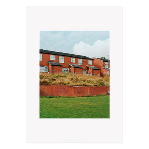 A reproduction of a photography work by Megan Dalton, featuring red bricked houses.