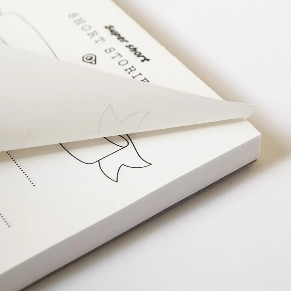 A piece of paper being torn from a tear-off notepad