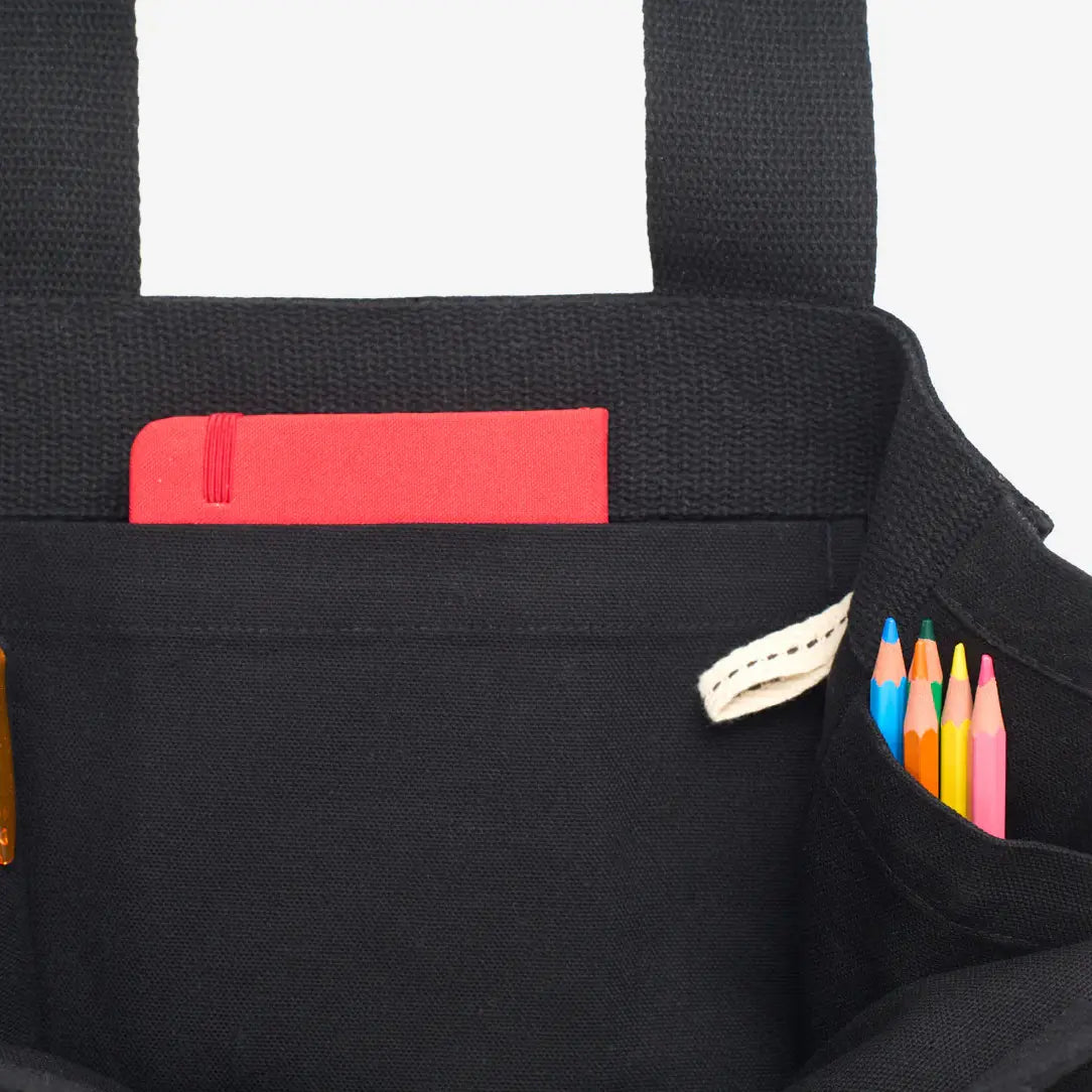 Black bag with a pocket containing colourful pencils and a red item.