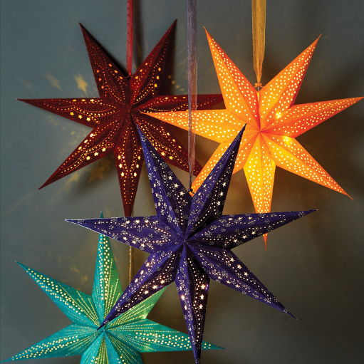 Four velvet hanging star decorations in red, orange, purple and blue, with light glowing from the inside. Photographed against a white background.