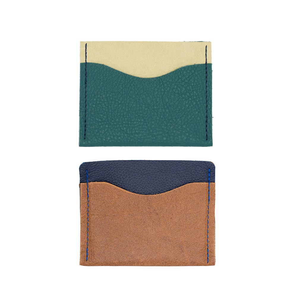 Image of a green and brown leather card wallets against white backdrop.