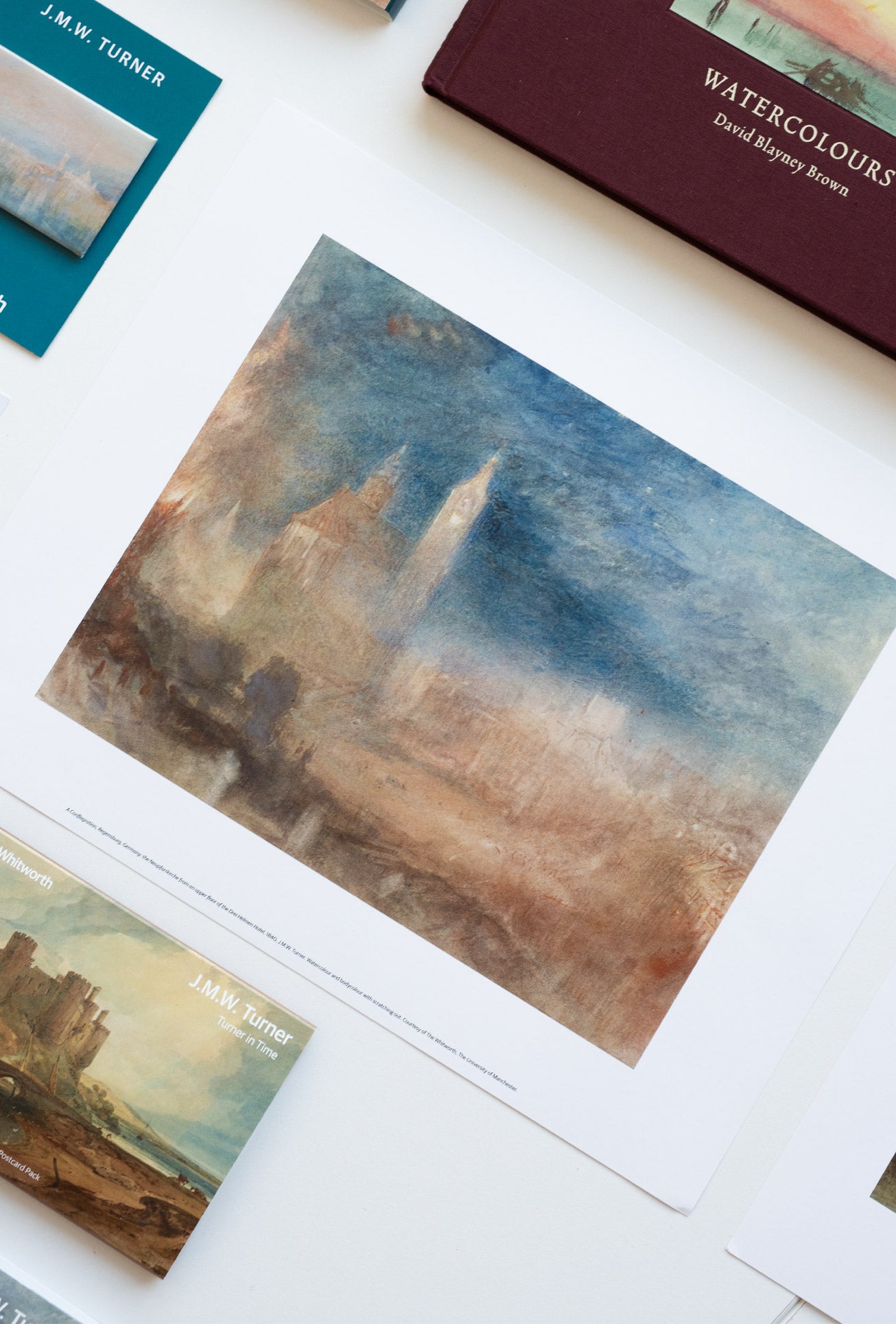 Collection of Turner watercolour reproductions on a white surface.