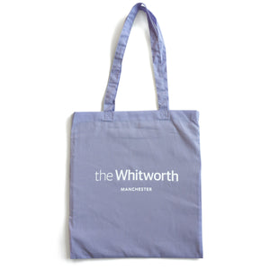 Lilac coloured tote bag with Whitworth logo against white background.