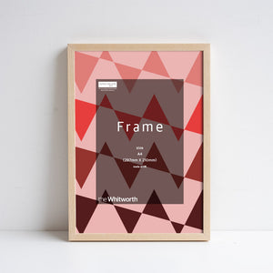 Ash frame leant against white wall