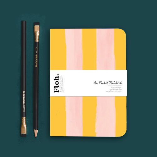 Yellow striped notebook against green backdrop