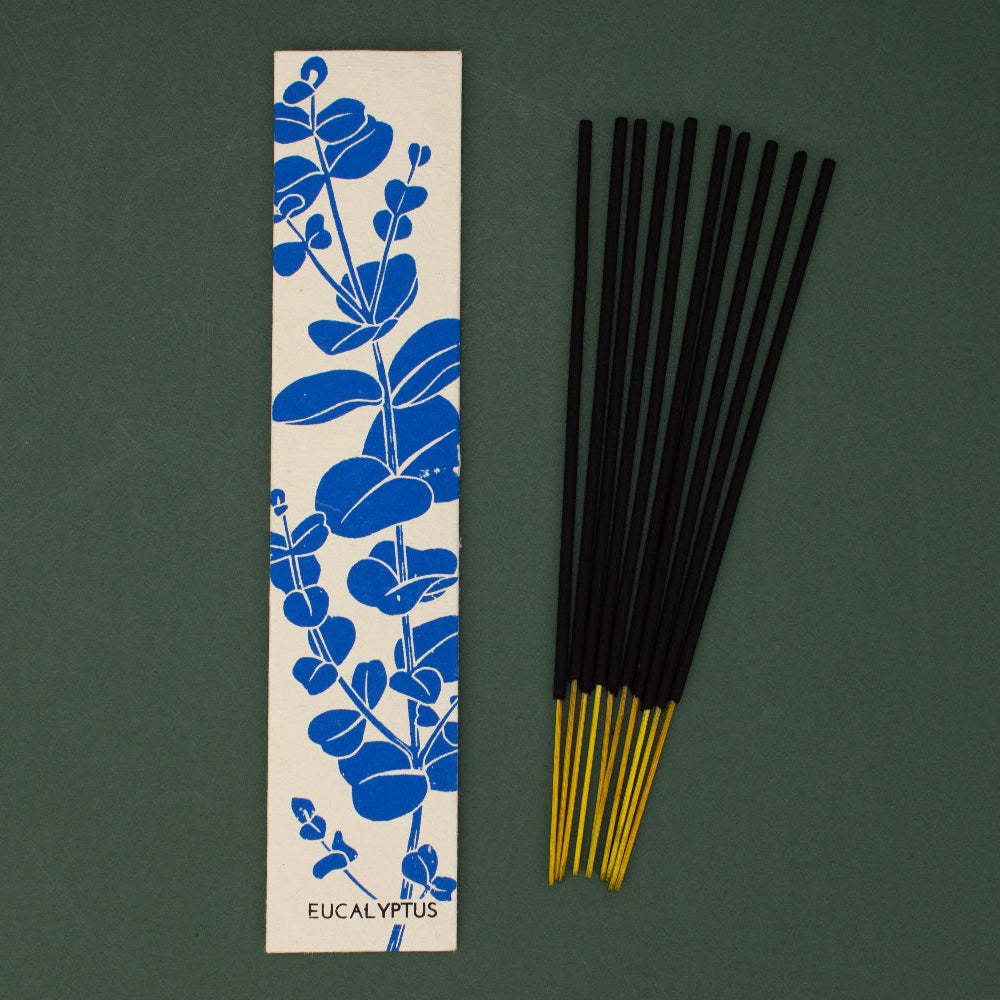 Incense sticks with a decorative box on a green background