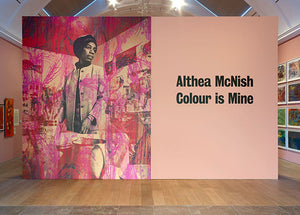 A wall within Althea McNish exhibition at the Whitworth. Features a photocollage with Althea McNish, and the exhibition title to the right.