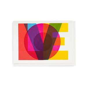 card with overlapping colourful letters spelling out LOVE. white envelope.