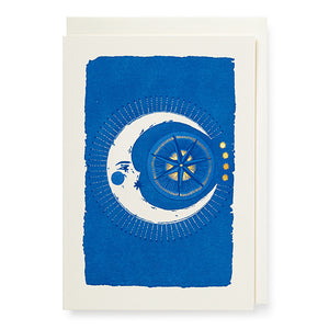 Greetings card with an illustration of a moon and sun against an electric blue background.